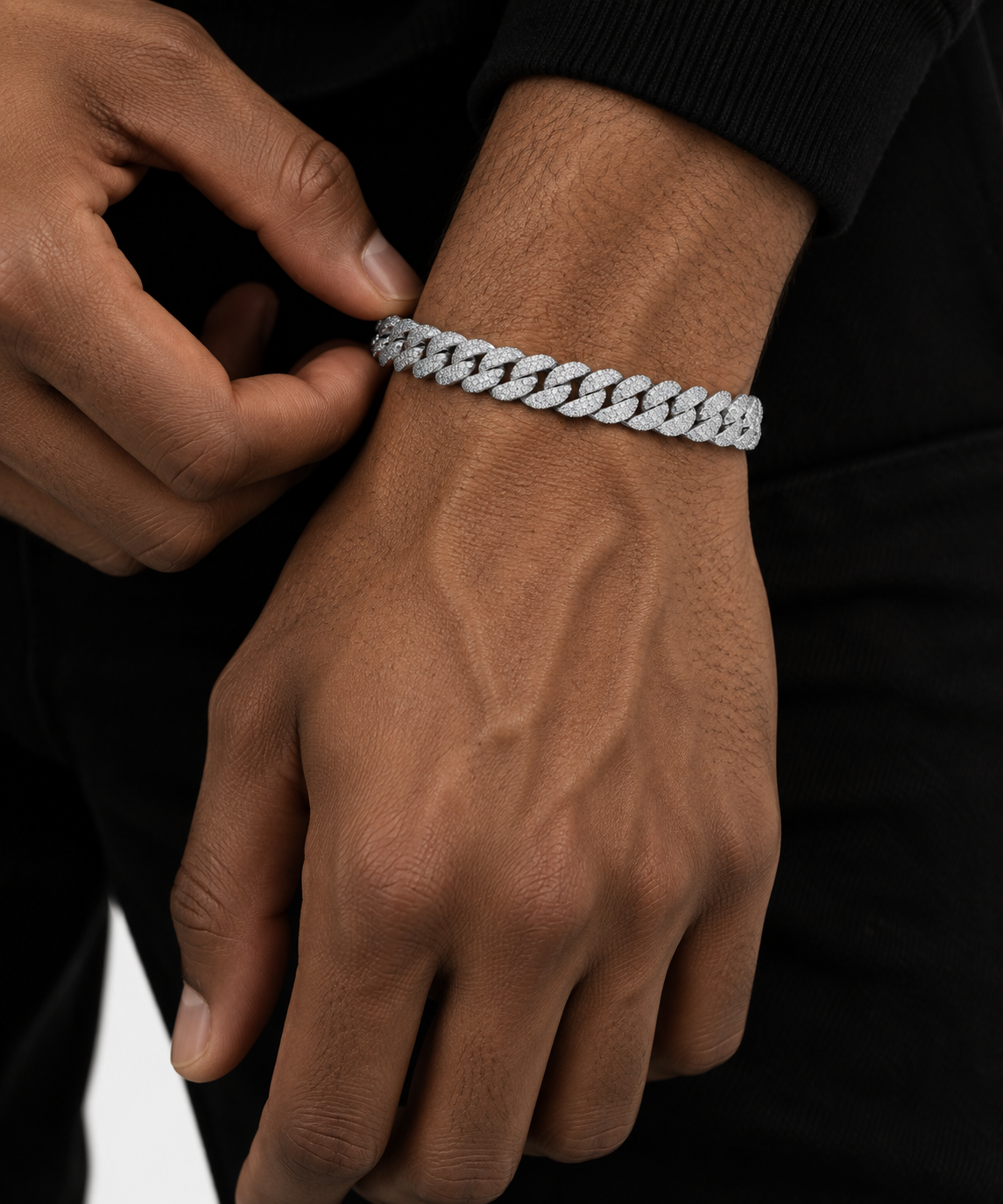 Silver-tone iced out Miami Cuban link bracelet worn on a wrist, micro-pave links